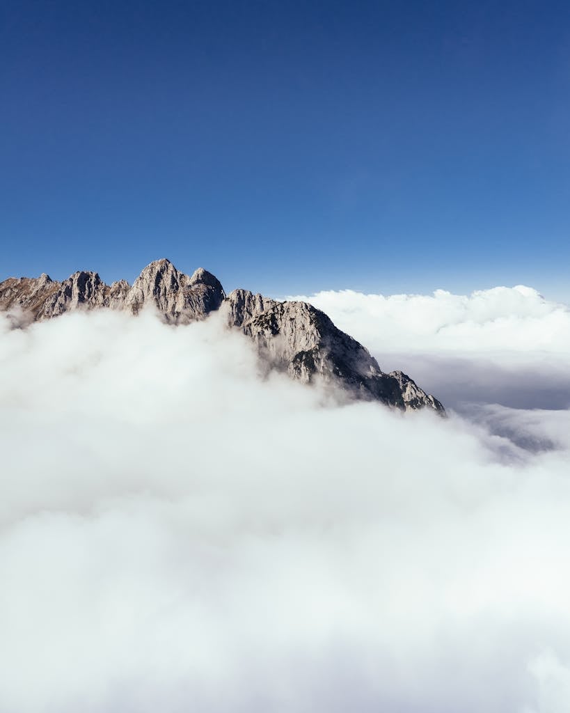 Aerial Photography of Mountain Covered With Thick Cloud Formation